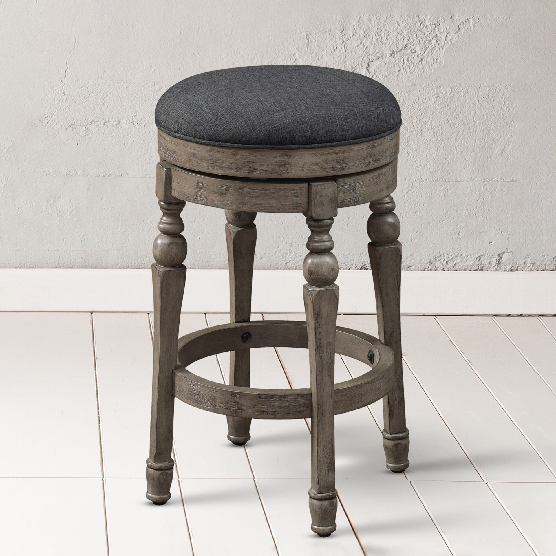 A dark gray stool with wooden legs