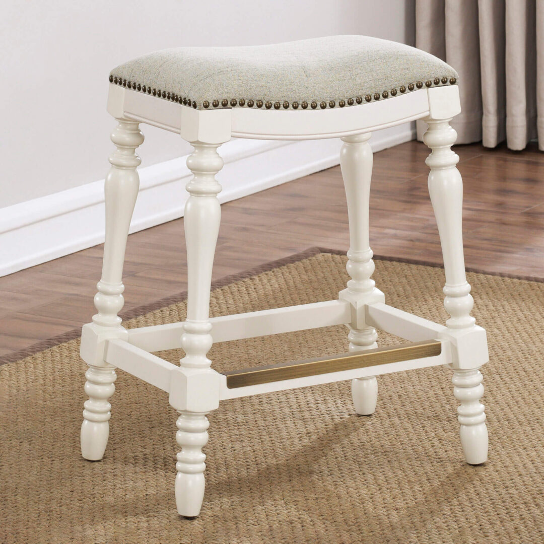 A khaki rectangular stool with white legs