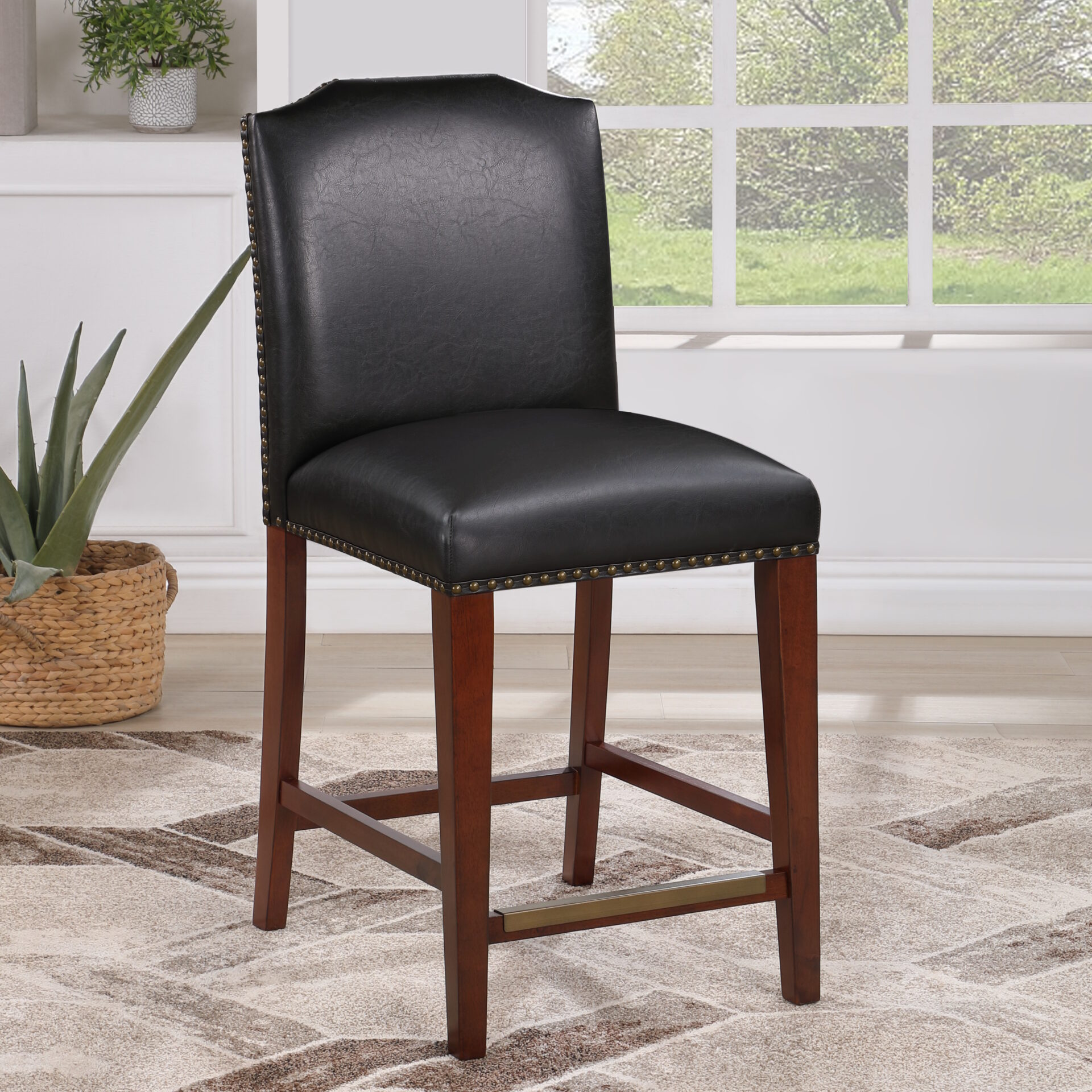 A picture of the black colored bar stool on the floor